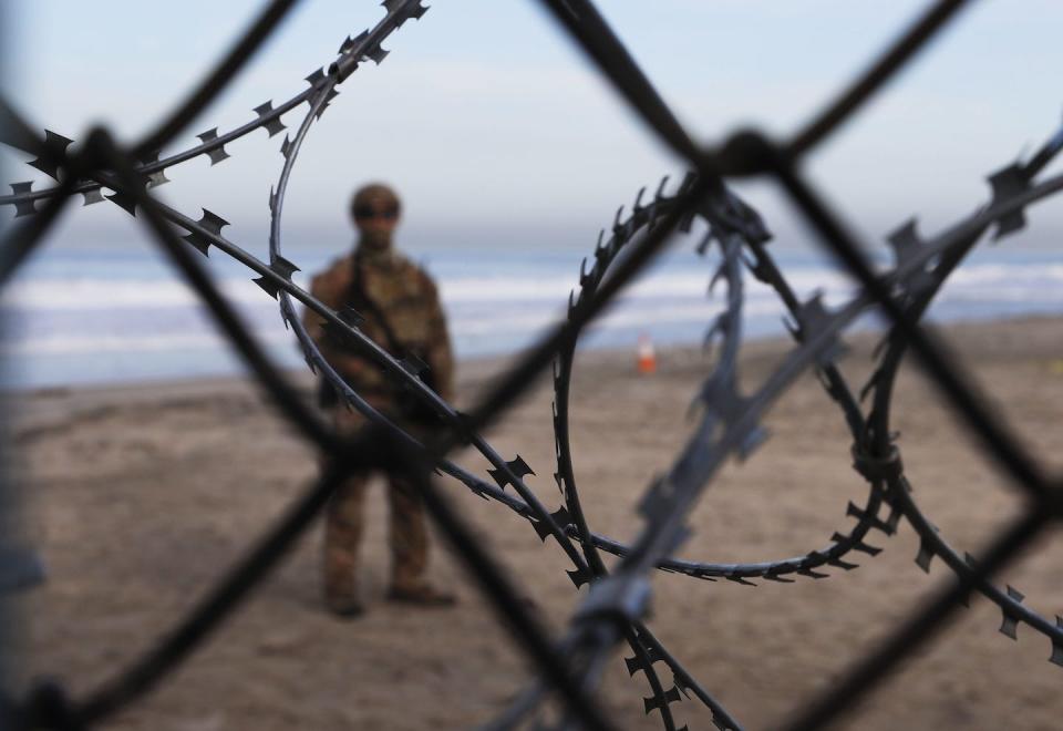 A U.S. Border Patrol agent stands on the American side of the U.S.-Mexico border in November 2018. (AP Photo/Marco Ugarte)