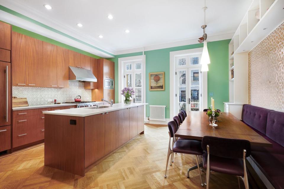 BEFORE: The kitchen Lisa and Michael inherited featured cherry cabinetry, which read as orange against turquoise walls.