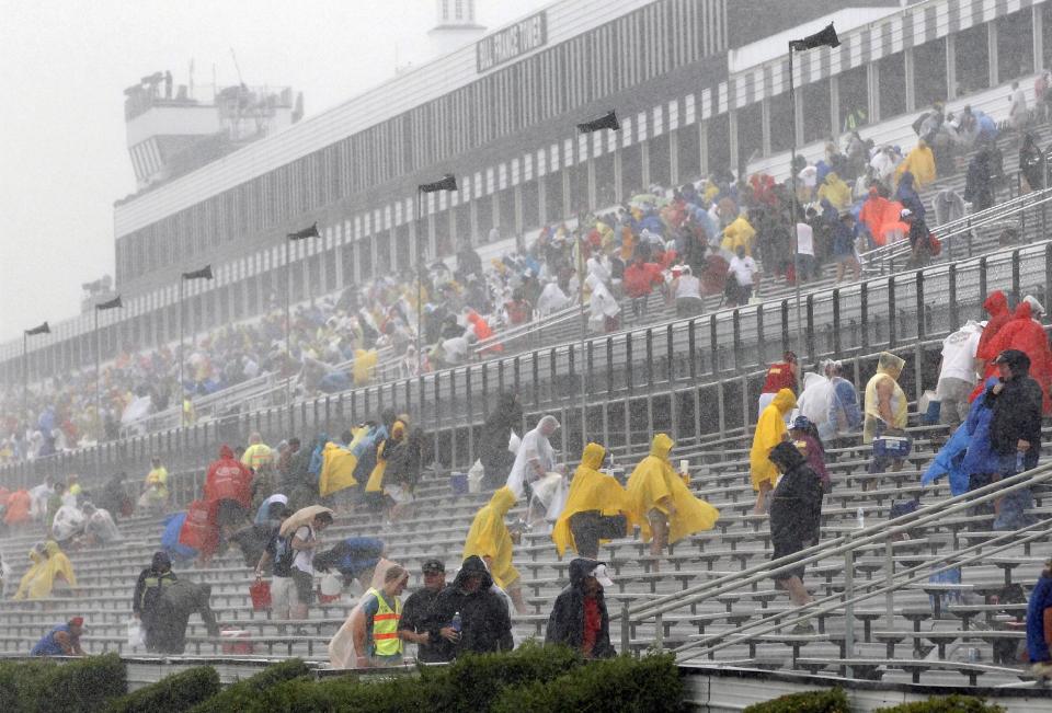 Fans leave the stands after the start of the NASCAR Sprint Cup Series auto race was postponed due to rain on Sunday, Aug. 5, 2012, at Pocono Raceway in Long Pond, Pa. (AP Photo/Mel Evans)