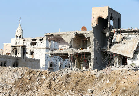 A damaged mosque and remains of buildings are seen following a security campaign against Shi'ite Muslim gunmen in the town of Awamiya, in the eastern part of Saudi Arabia August 9, 2017. REUTERS/Faisal Al Nasser