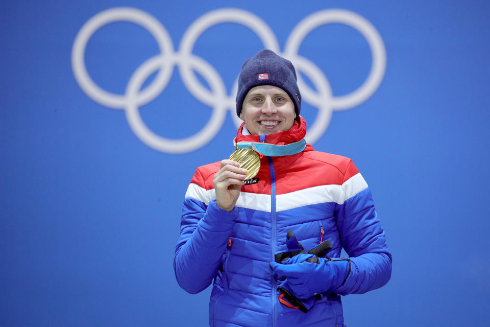 <p>Gold medalist Simen Hegstad Krueger of Norway celebrates on the podium during the Medal Ceremony for the Men’s Cross-Country Skiing 15 km + 15 km Skiathlon. </p>