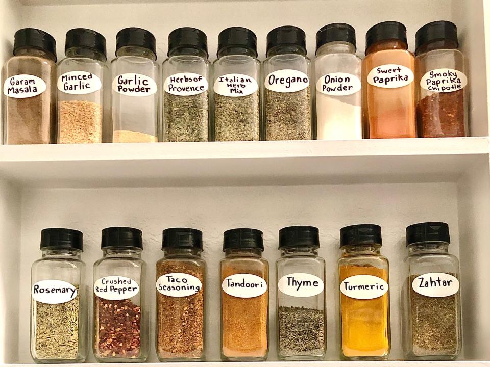 white spice rack with lots of different spices