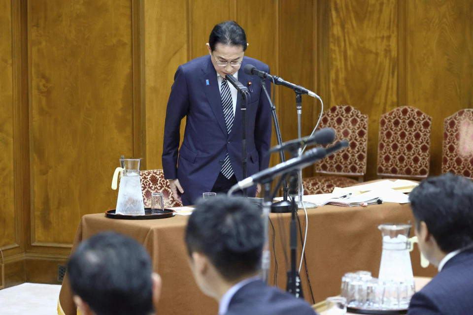 Japan's Prime Minister Fumio Kishida bows in apology for his governing party’s corruption scandal during a political ethics committee at parliament in Tokyo Thursday, Feb. 29, 2024. (Japan Pool/Kyodo News via AP)