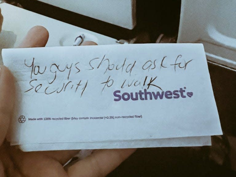 "You guys should ask for security to walk" note written on Southwest Airlines paper.