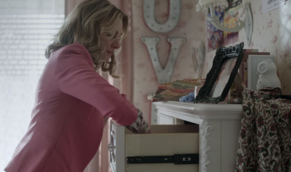 A woman going through a dresser drawer