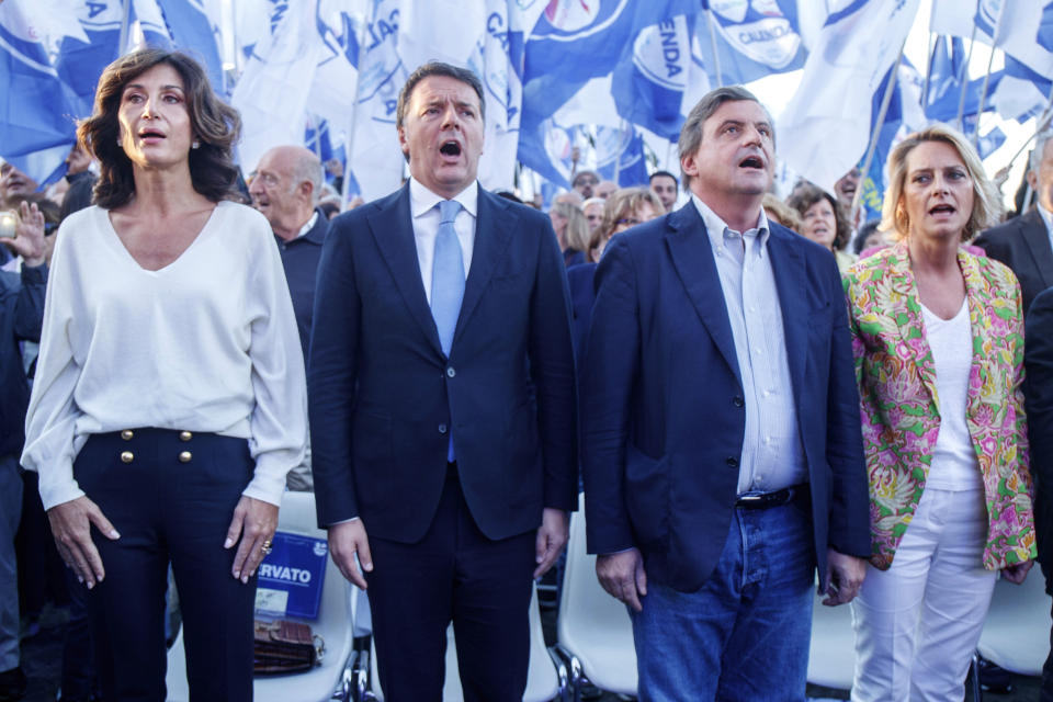 From left, Agnese Renzi, with his husband, former Italian Premier Matteo Renzi, Carlo Calenda, head of the centrist party Action, and his wife Violante Calenda attend a rally in Rome, Friday, Sep. 23, 2022. Italians vote on Sunday for a new Parliament, and they could elect their first far-right premier of the post-war era. If opinion polls hold, Giorgia Meloni could be that premier, as well as become the first woman to lead an Italian government. (Roberto Monaldo/LaPresse Via AP)