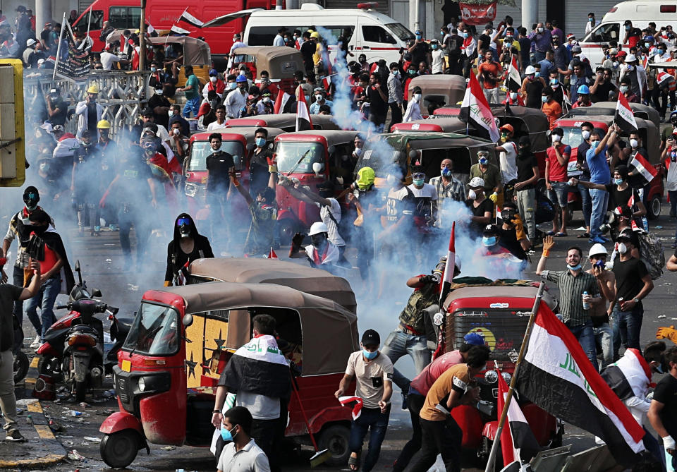 Iraqi security forces fire tear gas to disperse anti-government protesters during a demonstration in Baghdad, Iraq, Tuesday, Oct. 29, 2019. (AP Photo/Khalid Mohammed)