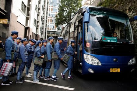 Participants dressed in replica red army uniforms board a bus to take part in a Communist team-building course extolling the spirit of the Long March, organised by the Revolutionary Tradition College, in the mountains outside Jinggangshan, Jiangxi province, China, September 14, 2017. REUTERS/Thomas Peter