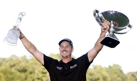 Henrik Stenson of Sweden holds up the trophy for winning the the Tour Championship golf tournament and the FedExCup trophy at East Lake Golf Club in Atlanta, Georgia, September 22, 2013. REUTERS/Tami Chappell