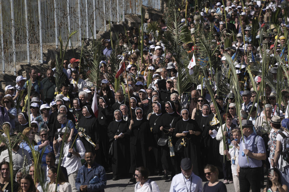 Christians walk in the Palm Sunday procession on the Mount of Olives in east Jerusalem, Sunday, April 2, 2023. The procession observes Jesus' entrance into Jerusalem in the time leading up to his crucifixion, which Christians mark on Good Friday. (AP Photo/Mahmoud Illean)