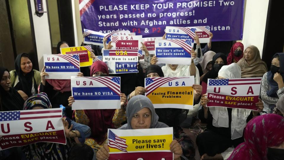 Afghan refugees hold an indoor rally in Islamabad, Pakistan, to demand their U.S. visa to be processed on July 21. (Rahmat Gul/AP)