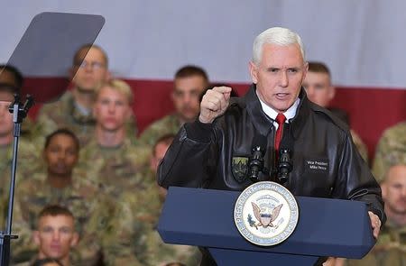 U.S. Vice President Mike Pence arrives on stage to address troops in a hangar at Bagram Air Field in Afghanistan on December 21, 2017. Picture taken December 21, 2017. REUTERS/Mandel Ngan/Pool