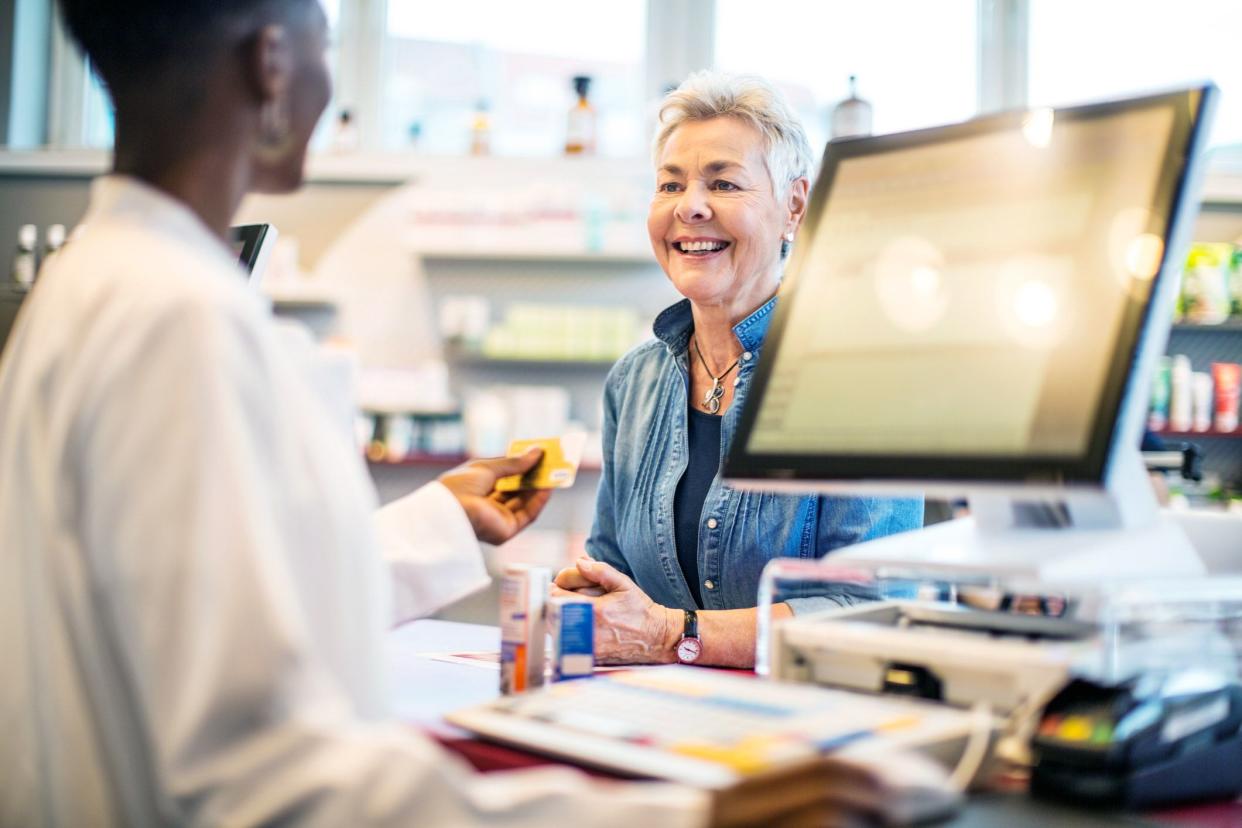 woman checking out at pharmacy