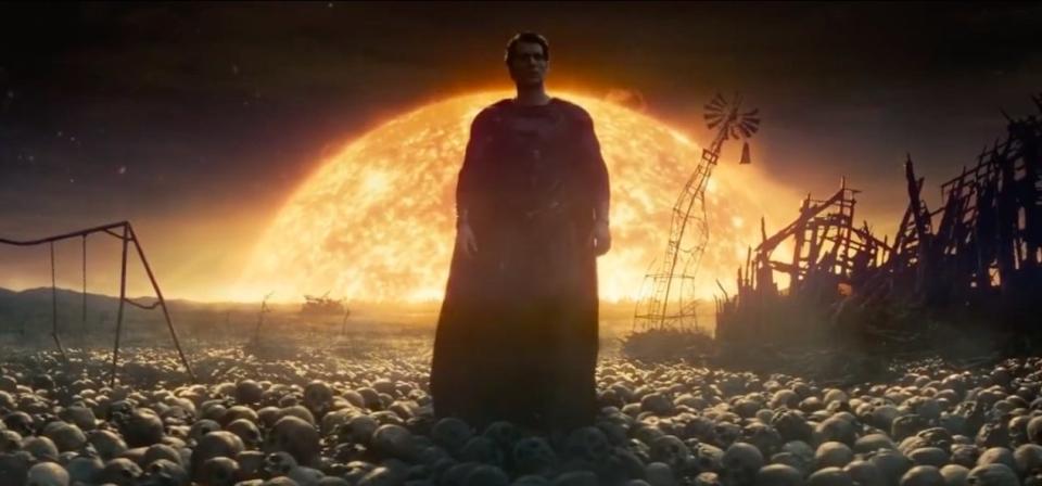 Superman standing over countless human skulls with the sun behind him in "Man of Steel"