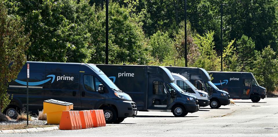 Amazon delivery vans are shown parked at the company's delivery facility on Industrial Road in Milford, Aug. 19, 2022.