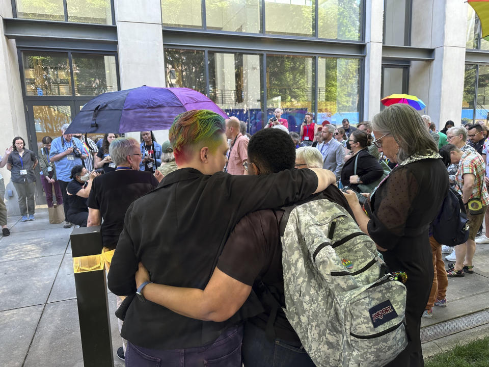 Those in the LGBTQ community and their allies gather outside the Charlotte Convention Center, in Charlotte, N.C., Thursday, May 2, 2024, to celebrate after the General Conference of the United Methodist Church voted to remove the denomination's 52-year-old social teaching that deemed homosexuality "incompatible with Christian teaching." (AP Photo/Peter Smith)