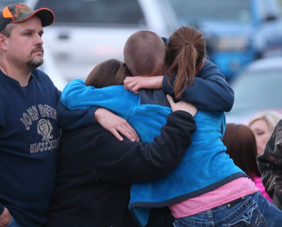 West resident hug each other during a moment of silence while attending the 4-17 Forever Forward ceremony, Thursday, April 17, 2014, in West, Texas. Today marks the one-year anniversary of the explosion. (AP Photo/Waco Tribune Herald, Rod Aydelotte)