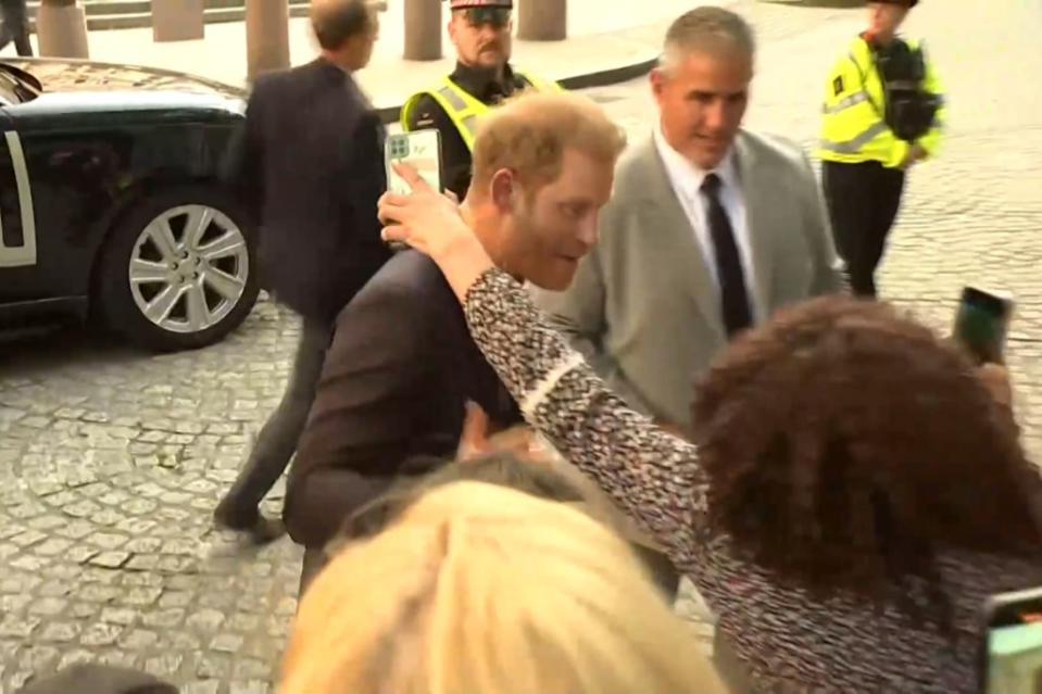 Prince Harry (center) had an awkward interaction with an overexcited fan in London. Reuters