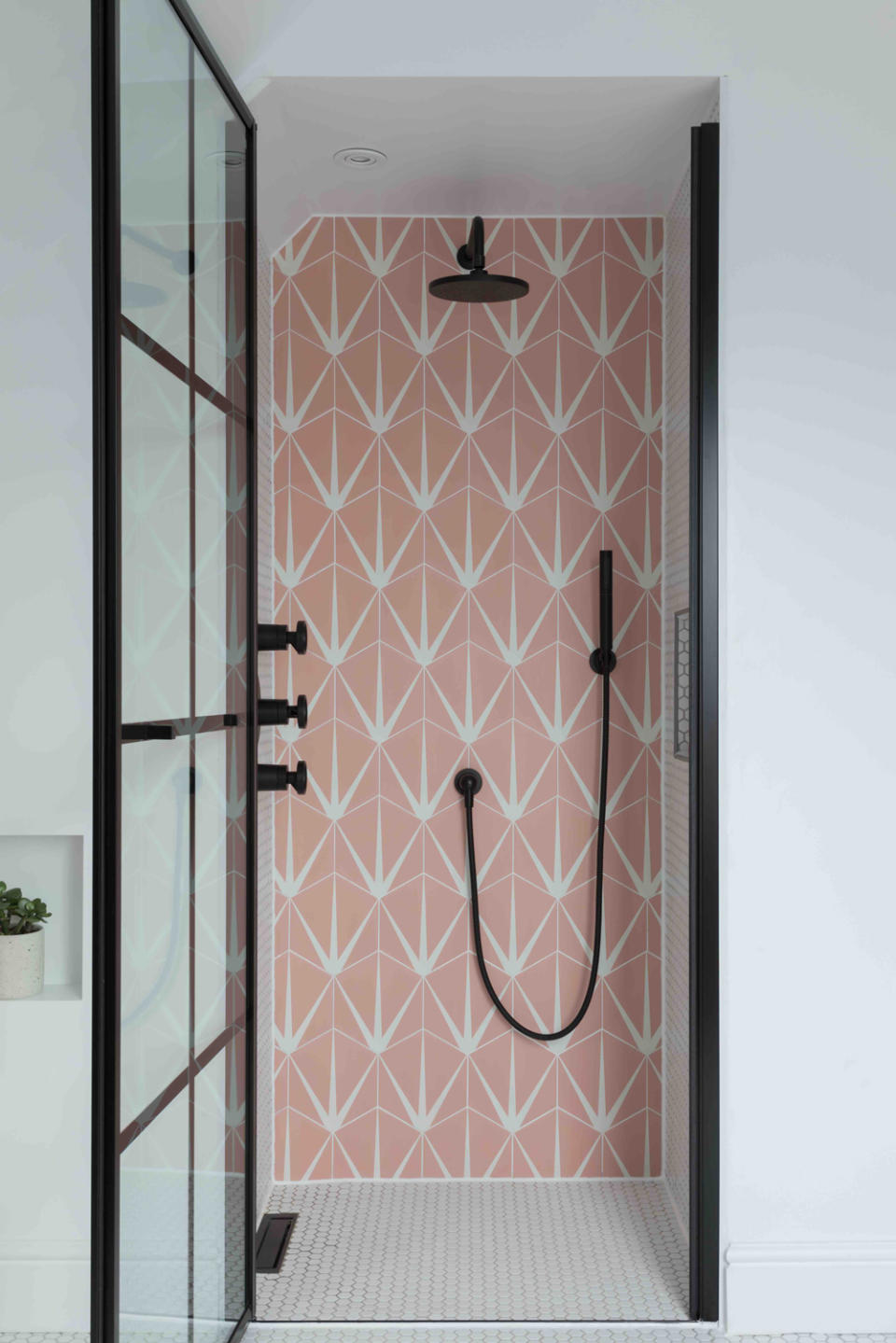 modern bathroom with pink geometric tiles and walk in shower