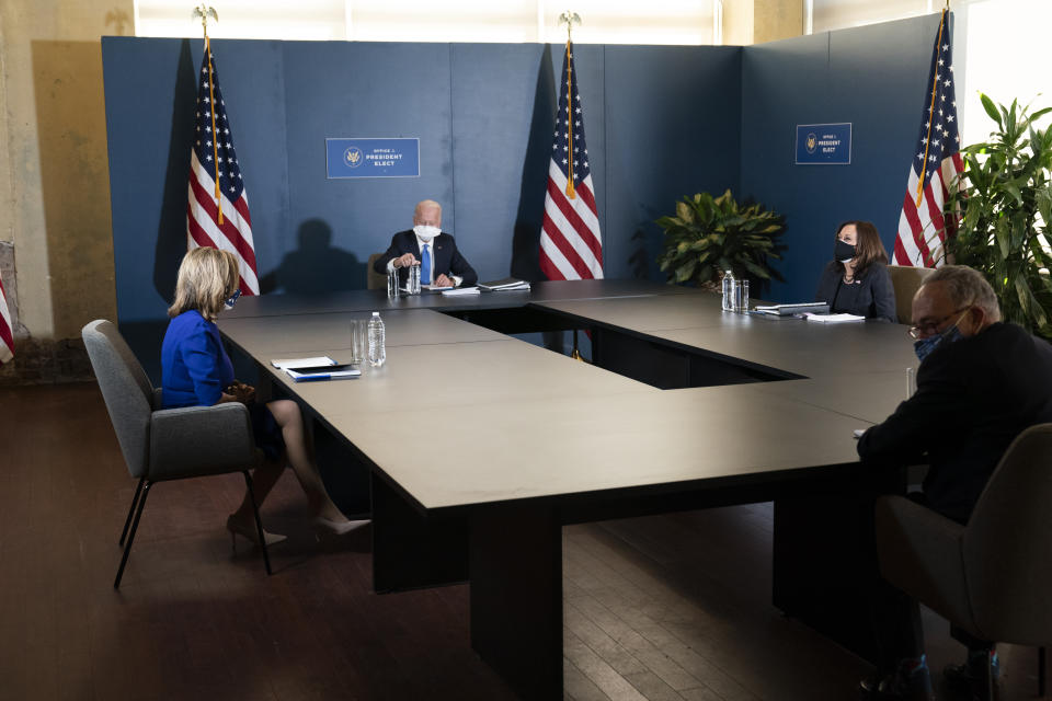 President-elect Joe Biden, speaks during a meeting with Vice President-elect Kamala Harris, right, Senate Minority Leader Chuck Schumer of N.Y., and House Speaker Nancy Pelosi of Calif., left, Friday, Nov. 20, 2020, in Wilmington, Del. (AP Photo/Alex Brandon)