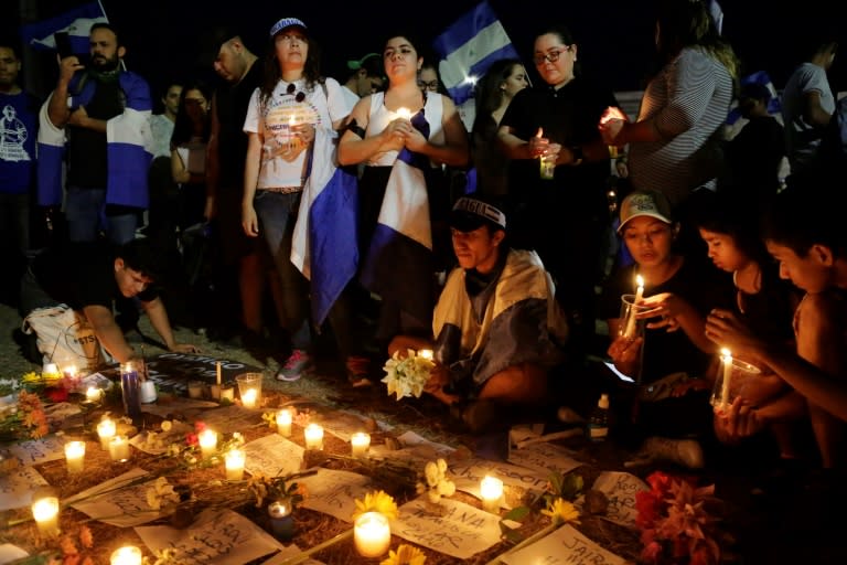 Students in Managua carry candles during a protest demanding Nicaraguan President Daniel Ortega and his wife, Vice President Rosario Murillo to step down