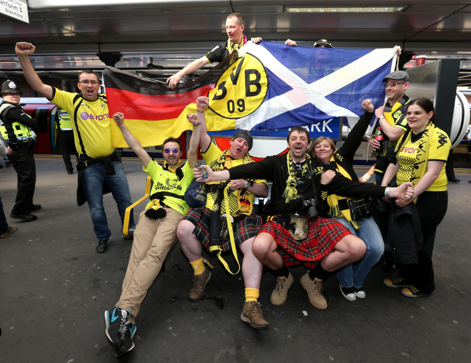 Borrussia Dortmund's fans pose for photographs at Wembley Park tube station before the Champions League Final at Wembley, London.