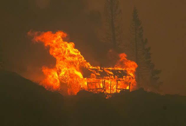 In Meyers, California, a structure is seen up in flames as the Caldor fire descends into the Tahoe Basin on Aug. 30. (Photo: MediaNews Group/The Mercury News via Getty Images via Getty Images)