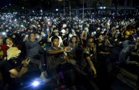 Pro-democracy activities display mobile phones with flash lights on during a protest at Democracy Monument in Bangkok, Thailand, Sunday, Aug, 16, 2020. A two-day rally planned for this weekend is jangling nerves in Bangkok, with apprehension about how far student demonstrators will go in pushing demands for reform of Thailand’s monarchy and how the authorities might react. More than 10,000 people are expected to attend the Saturday-Sunday event. (AP Photo/Gemunu Amarasinghe)