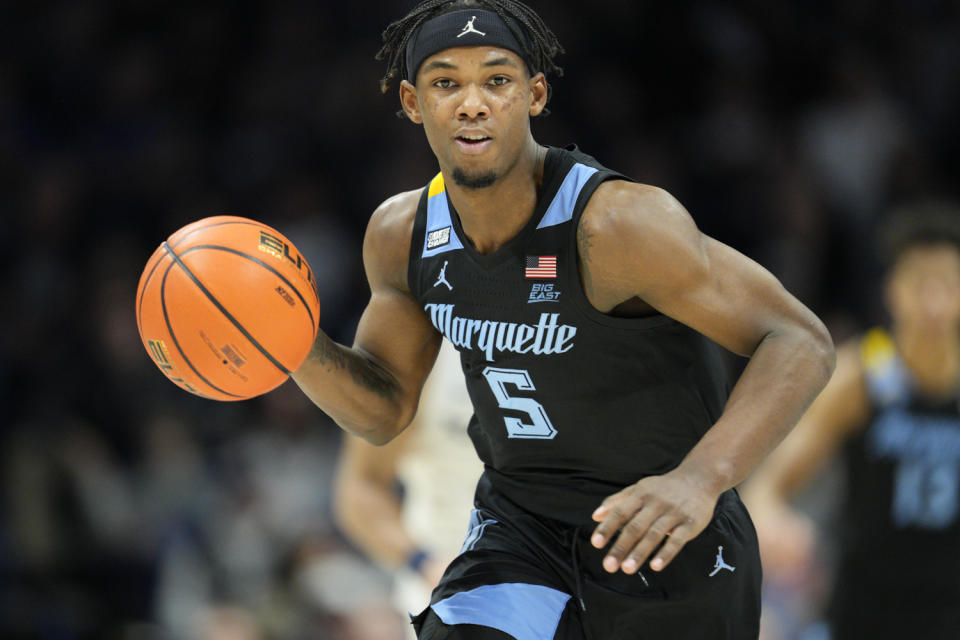 Marquette guard Chase Ross controls the ball during the second half of an NCAA college basketball game against Xavier, Sunday, Jan. 15, 2023, in Cincinnati. (AP Photo/Jeff Dean)