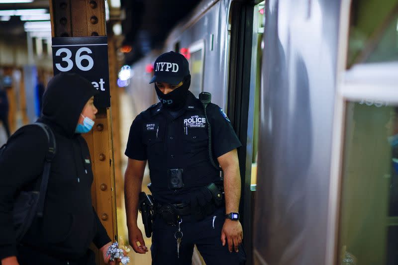 FILE PHOTO: A New York Police Officer of the anti terrorism unit patrols the 36th St. subway station, a day after a shooting incident took place in the Brooklyn borough of New York