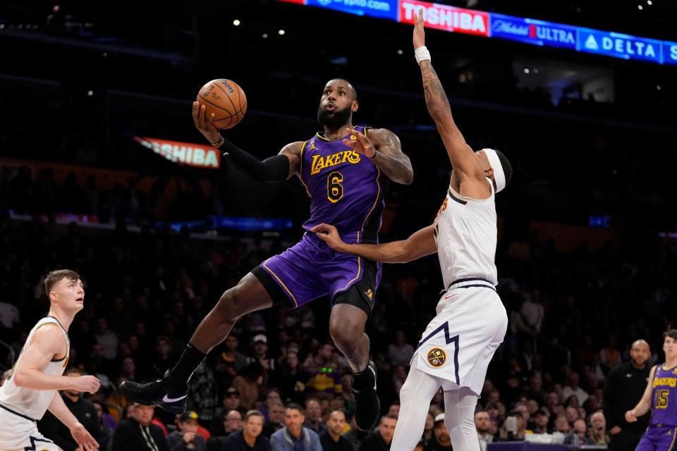 Los Angeles Lakers forward LeBron James (6) shoots against Denver Nuggets forward Bruce Brown, right, during the first half of an NBA basketball game in Los Angeles, Friday, Dec. 16, 2022. (AP Photo/Ashley Landis)