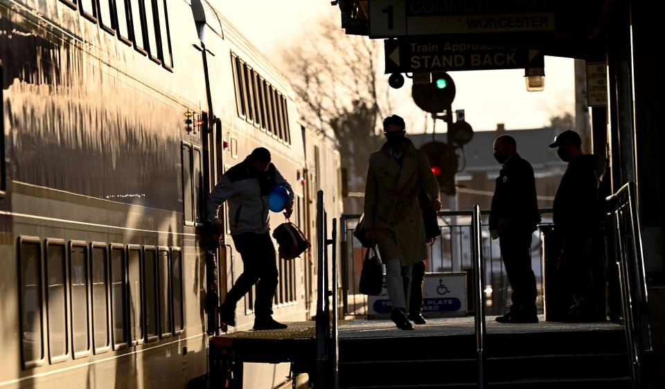 Passengers are shown stepping off an evening commuter train in downtown Framingham in March 2021. The Framingham Commuter Rail stop drops passengers off right near the 6.6-mile mark of the Boston Marathon, on Waverly Street (Route 135).