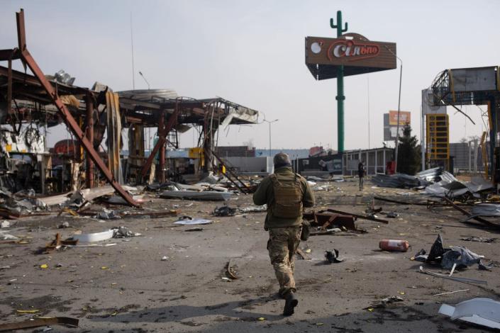 <span class="caption">The destroyed fuel station in Stoyanka, Ukraine. Putin has been laying the rhetorical groundwork for the invasion of Ukraine for years. </span> <span class="attribution"><a class="link " href="https://www.gettyimages.com/detail/news-photo/ukrainian-serviceman-walks-by-the-destroyed-fuel-station-on-news-photo/1239644673?adppopup=true" rel="nofollow noopener" target="_blank" data-ylk="slk:Anastasia Vlasova/Getty Images">Anastasia Vlasova/Getty Images</a></span>
