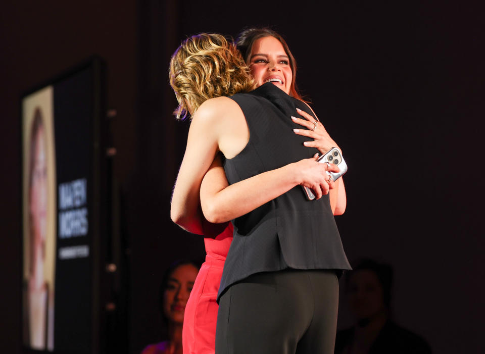 Honoree Marren Morris hugs Maggie Rogers on stage at Variety’s Hitmakers.