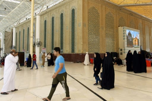 Visitors stroll around a holy site in the Iraqi city of Najaf, a key destination for Iranian Shiite pilgrims, on August 14, 2018