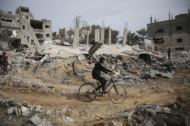 Palestinians inspect the ruins of a residential building for the Abu Muammar family after an Israeli airstrike in Rafah, southern Gaza Strip, Friday, March 29, 2024