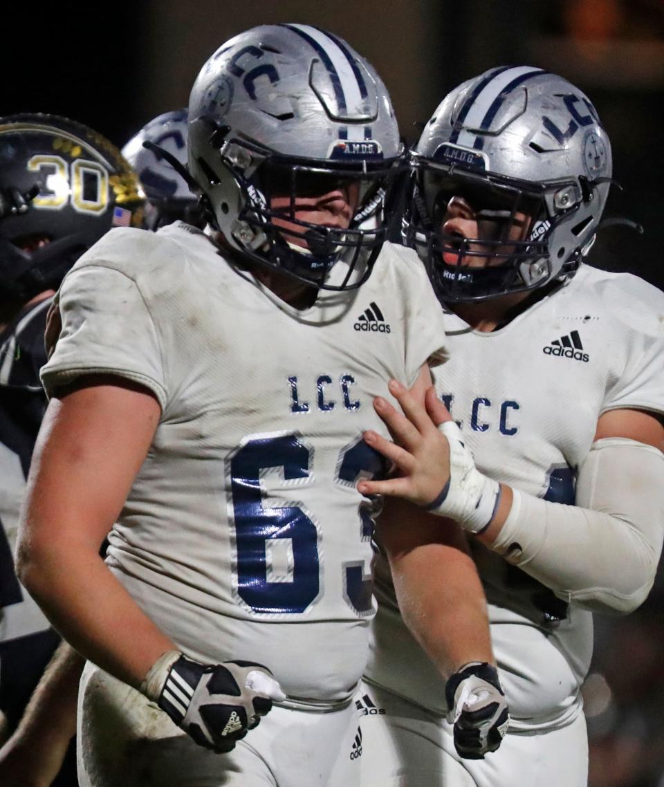 Central Catholic Knights Aiden Schaefer (63) and Central Catholic Knights Will Spencer (54) celebrate after making a stop during the IHSAA football sectional championship against the Rochester Zebras, Friday, Nov. 4, 2022, at Rochester High School in Rochester, Ind. Central Catholic won 24-8.