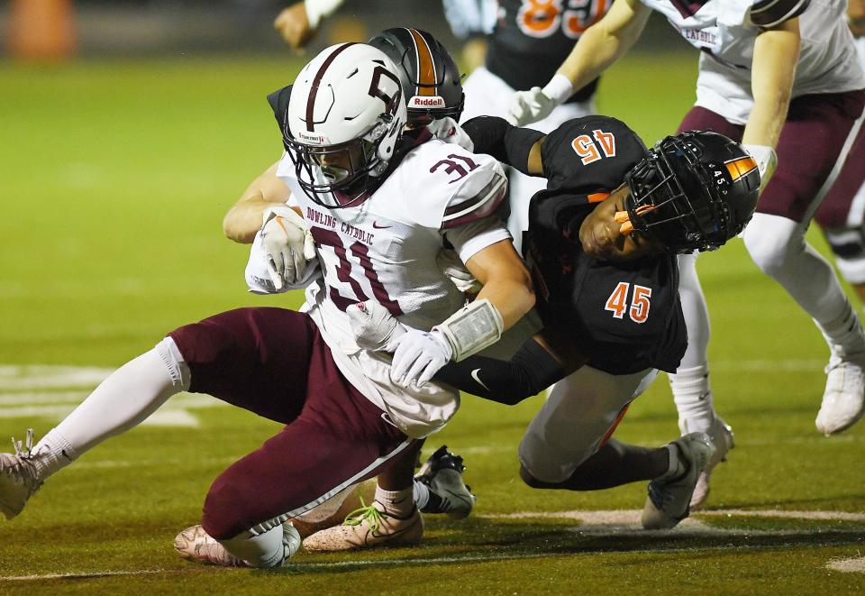Ames' defensive back DeShawn Long (45) takes down Dowling Catholic running back Jack Moore (31) on Oct. 7 in Ames
