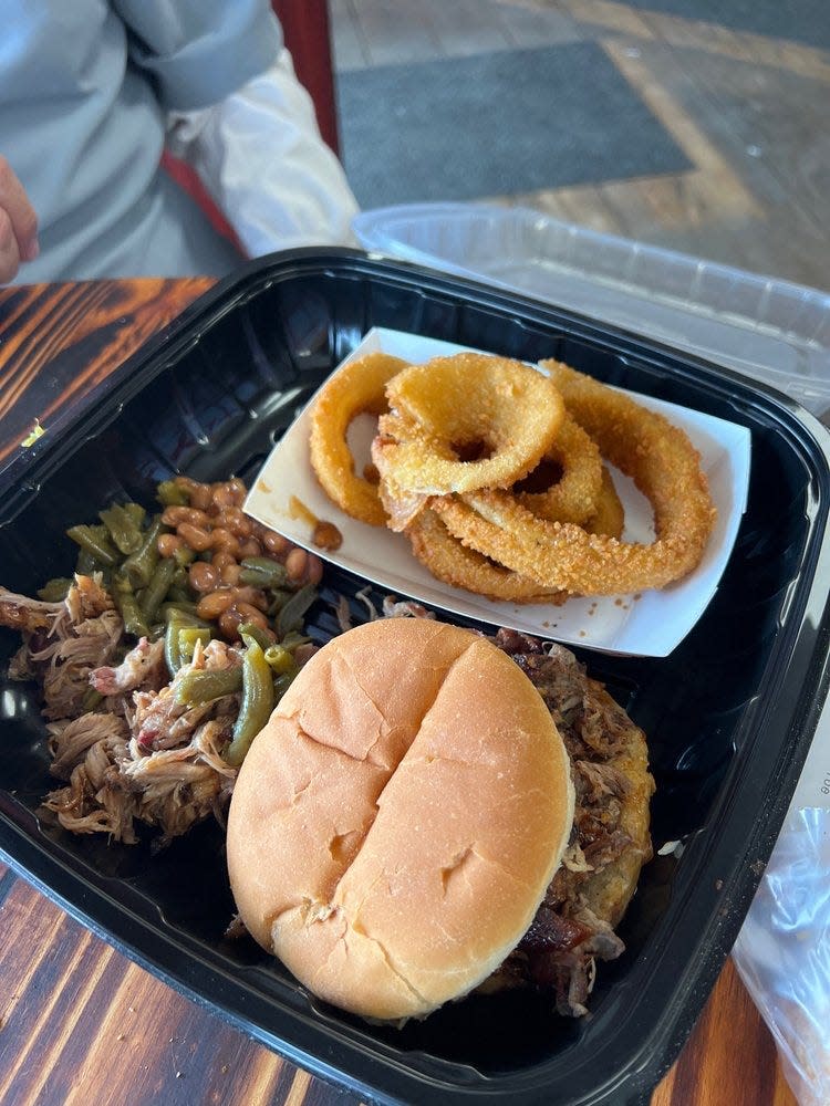 A plate of food, featuring a pulled pork sandwich, from Bully Barbeque.
