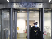 Police officer outside the main entrance of St Bartholomew's Hospital where Britain's Prince Philip is being treated, in London, Thursday, March 4, 2021. Buckingham Palace said Thursday that Prince Philip has undergone a successful procedure for a pre-existing heart condition, and will remain in hospital "for a number of days." (AP Photo/Alberto Pezzali)