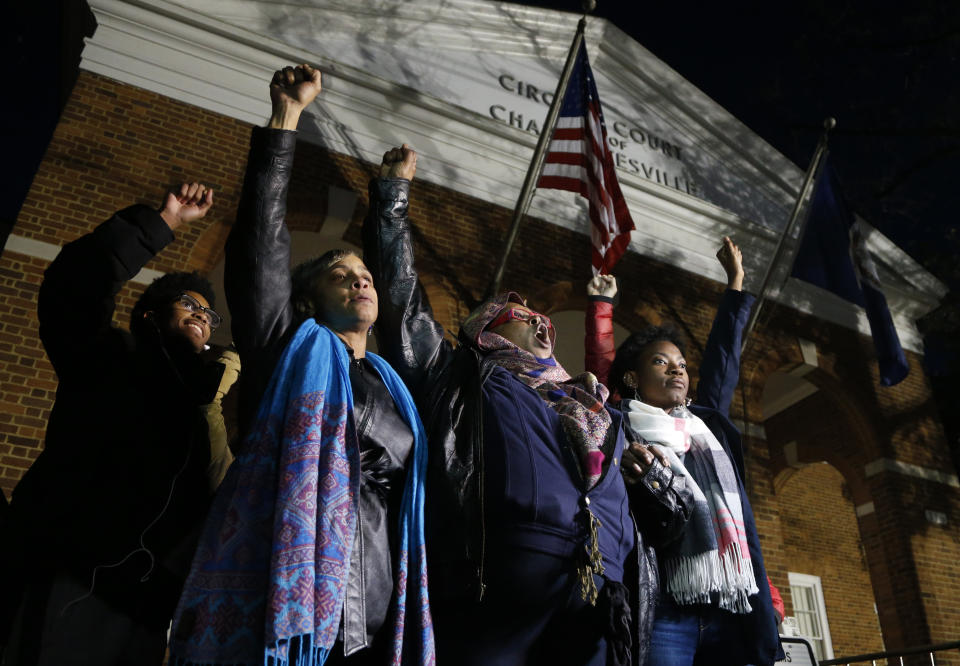 Local activists raise their fists outside Charlottesville General District Court after a guilty verdict was reached in the trial of James Alex Fields Jr., in Charlottesville, Va., Friday, Dec. 7, 2018. Fields was convicted of first degree murder in the death of Heather Heyer as well as nine other counts during a "Unite the Right" rally in Charlottesville . (AP Photo/Steve Helber)