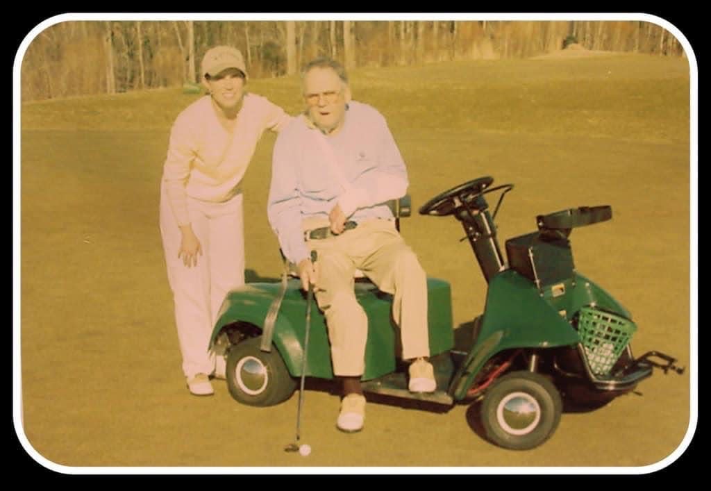 Sandy Halkett poses for a picture with father John Ligon, also known as Coach Big John, on the golf course.