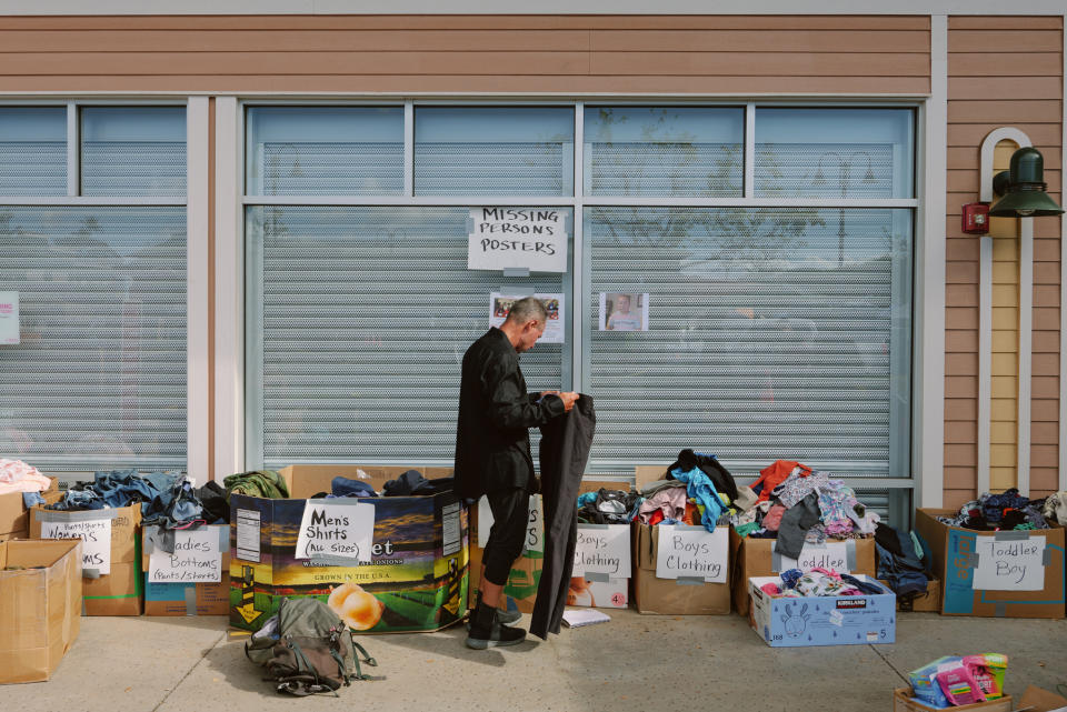 A man looks through clothing at a donation site in Lahaina, Maui, Hawaii on Aug. 16, 2023. (Josiah Patterson for NBC News)