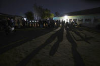 Voters are seen in a queue at a polling station in Harare, Wednesday, Aug. 23, 2023. Delays of up to 10 hours in mostly opposition strongholds marked voting in Zimbabwe on Wednesday as President Emmerson Mnangagwa seeks a second and final term in a country with a history of violent and disputed elections. (AP Photo/Tsvangirayi Mukwazhi)