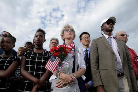People watch as U.S. President Barack Obama, Defense Secretary Ash Carter and Joint Chiefs Chair Gen. Joseph Dunford take part in a ceremony marking the 15th anniversary of the 9/11 attacks at the Pentagon in Washington, U.S., September 11, 2016. REUTERS/Joshua Roberts