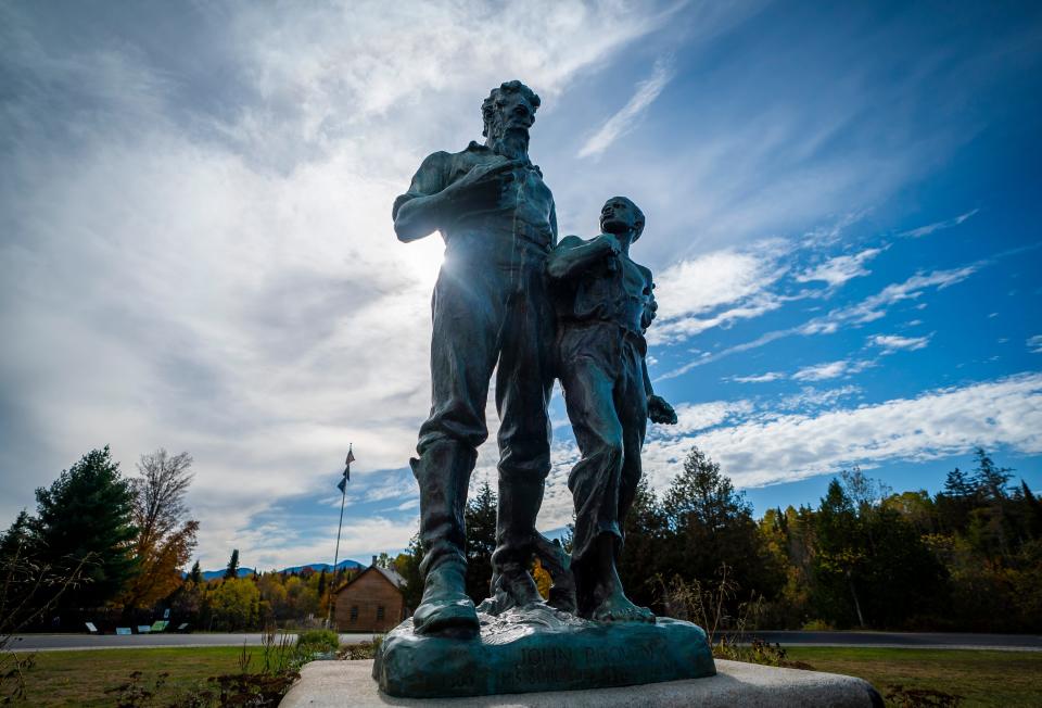 A statue of John Brown with an enslaved boy greets visitors to the John Brown Farm historic site in North Elba, New York, where Brown is buried. A militant abolitionist, Brown attacked a federal armory on October 16, 1859, in Harpers Ferry in what was then Virginia in hopes of sparking an armed slave uprising.