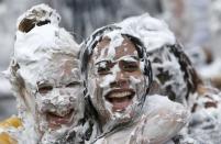 Students from St Andrews University are covered in foam as they take part in the traditional 'Raisin Weekend' in the Lower College Lawn, at St Andrews in Scotland, Britain October 17, 2016. REUTERS/Russell Cheyne