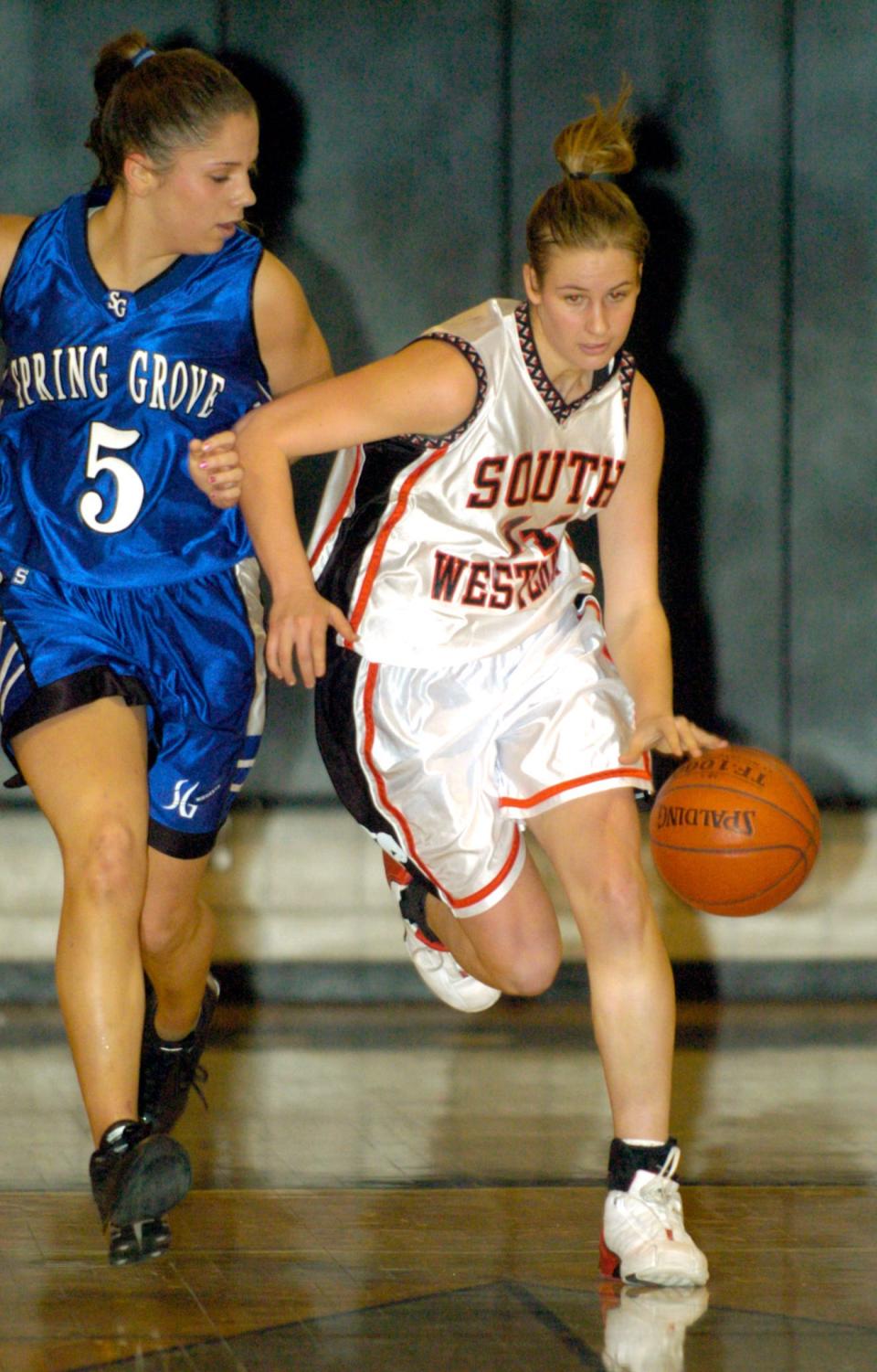 South Western's Nikki Lobach, right, drives downcourt with Spring Grove's Amanda McKim chasing in 2004.  Lobach graduated as the Mustangs' all-time leader in points.