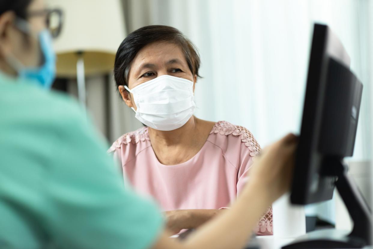 Woman looking at a monitor in a medical facility.