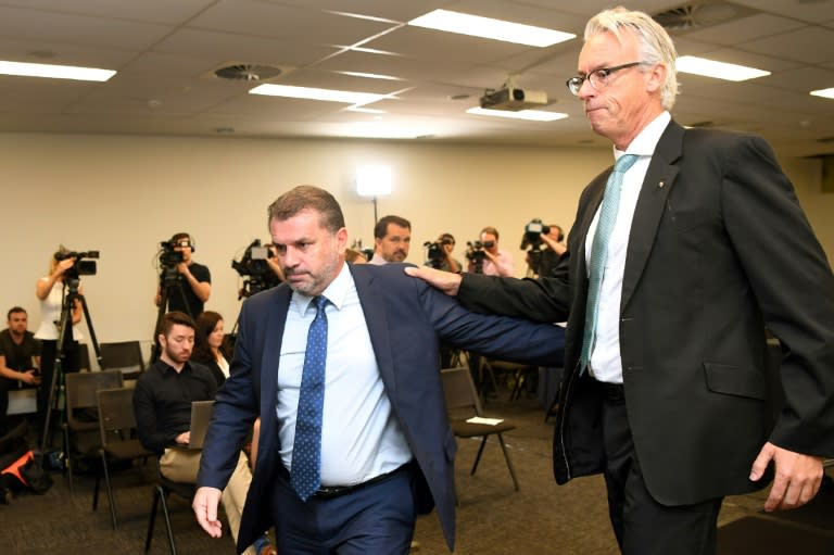 Australia's national football coach Ange Postecoglou leaves a press conference with Football Federation of Australia (FFA) chief David Gallop (R) after announcing his resignation in Sydney on November 22, 2017